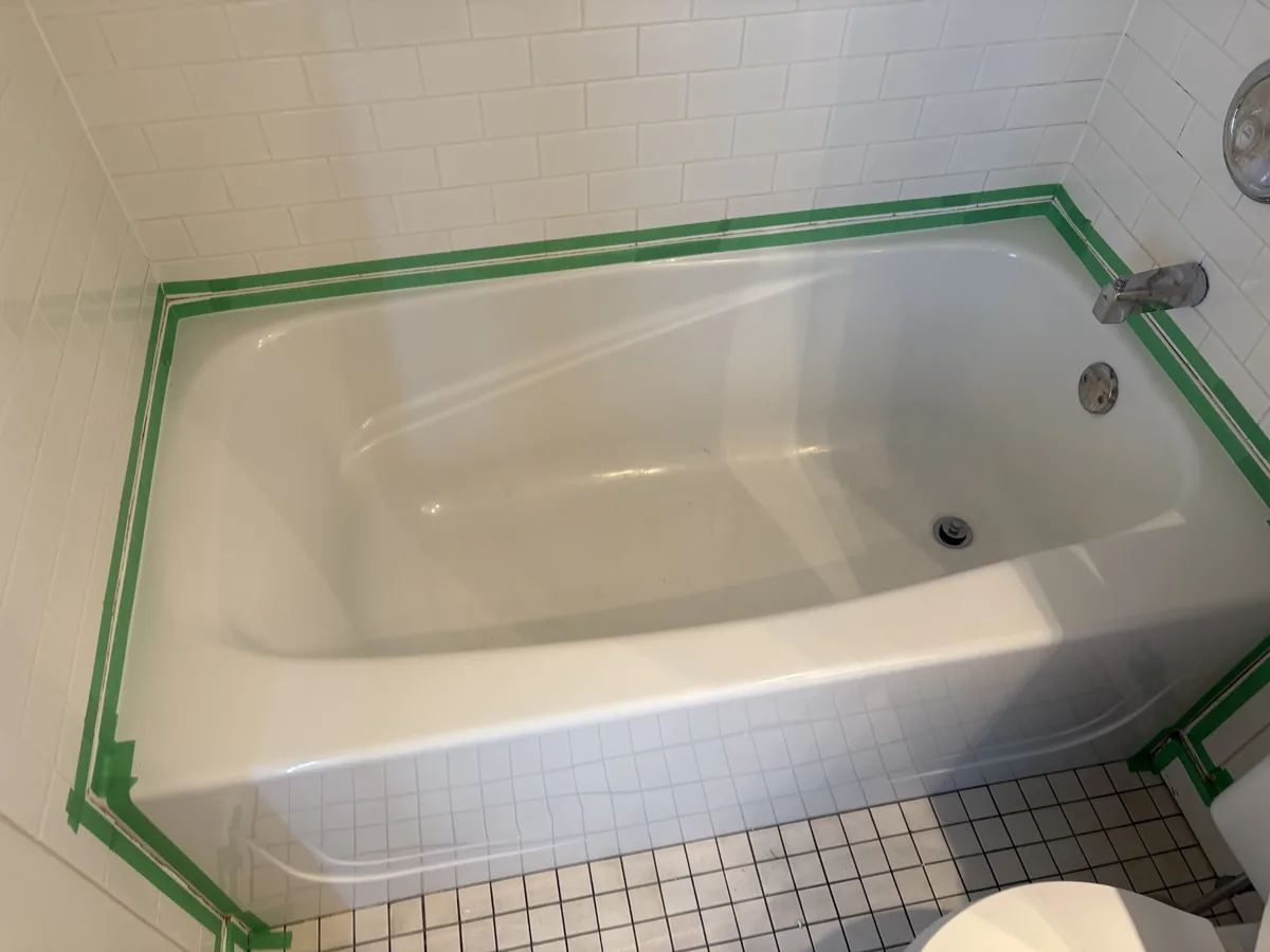 Bathroom tub reseal with glass shower panel